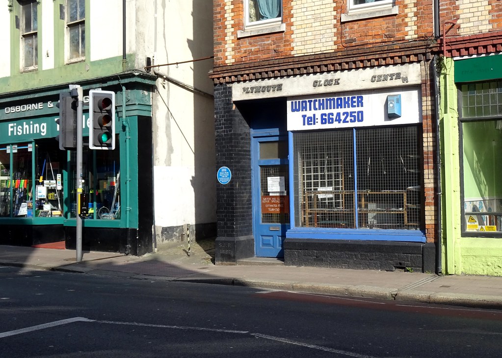 41 Bretonside frontage showing the blue plaque mounted on the brickwork, photographed before The Old Queeriosity Shop took the lease.